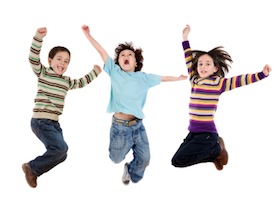Three happy children jumping at once